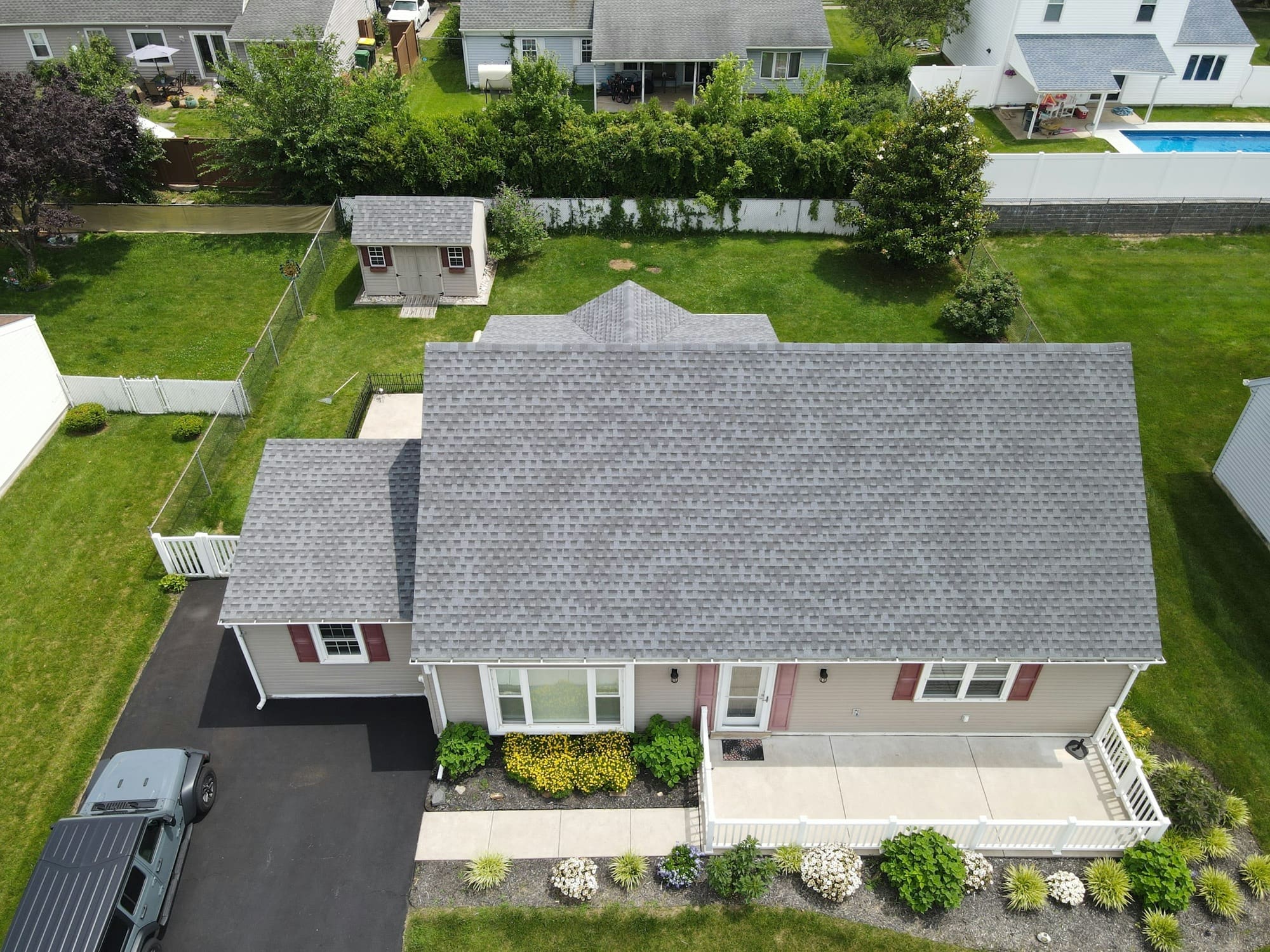 Aerial view of a suburban home’s roof, showing its size and pitch